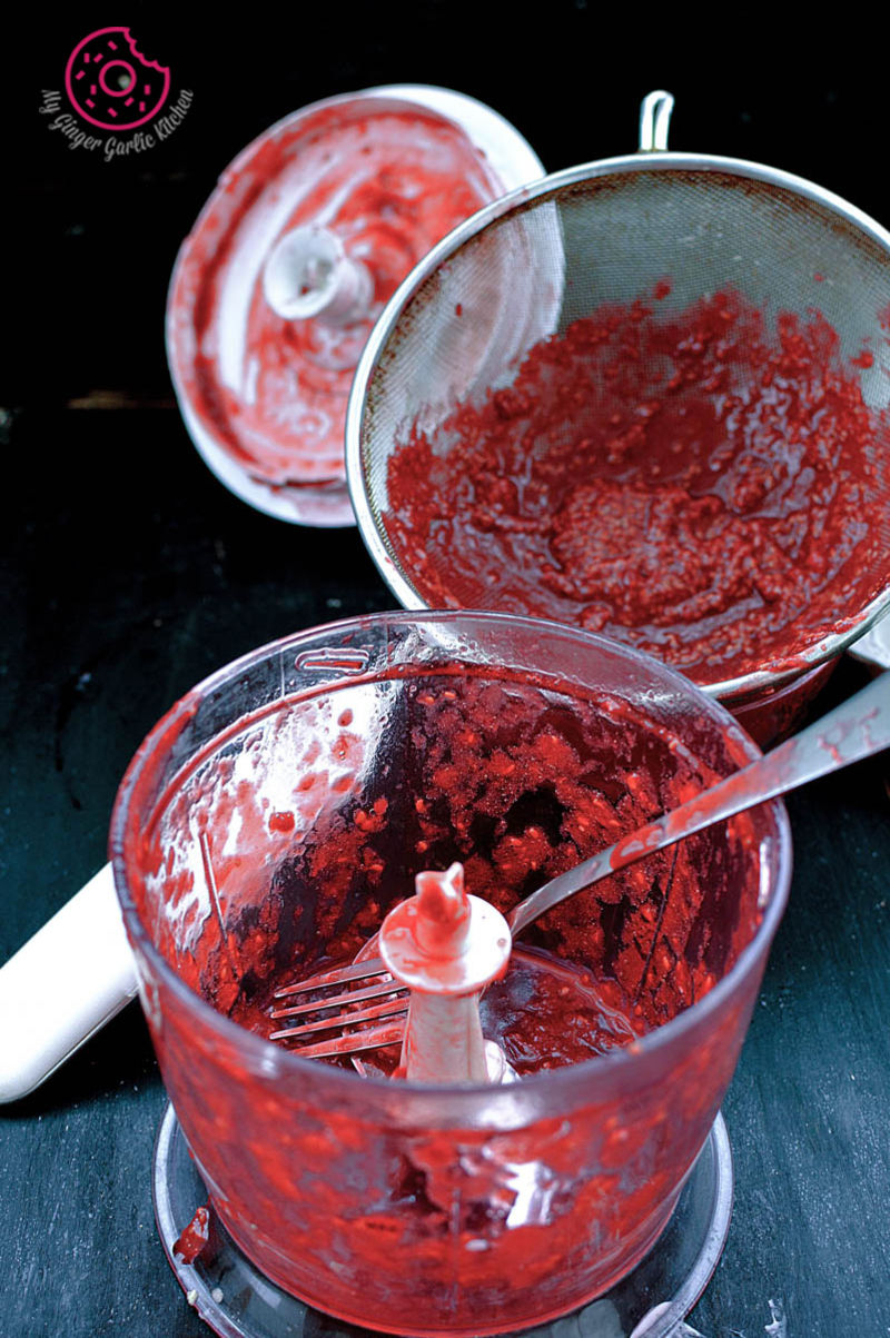 a red liquid in a bowl with a spoon