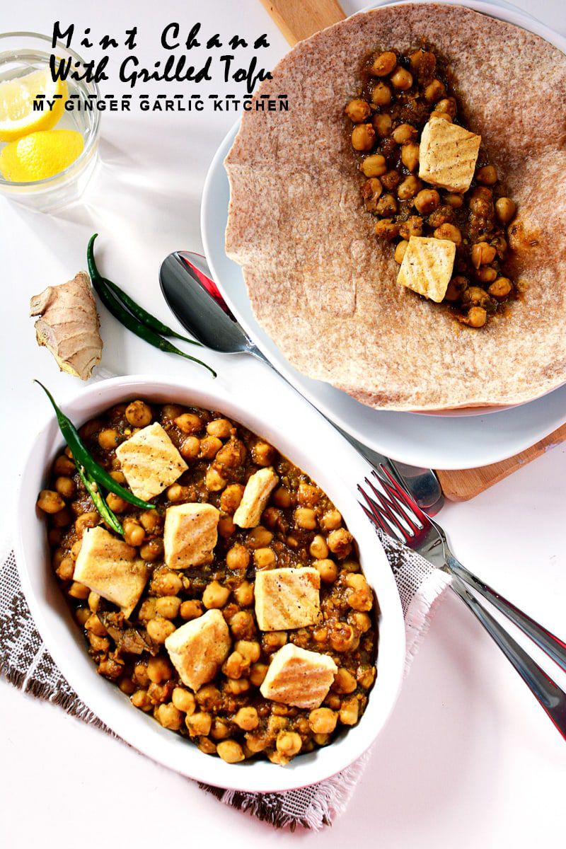 a bowl of mint chana with grilled tofu and a plate tortilla with chickpeas with a glass of water on the side