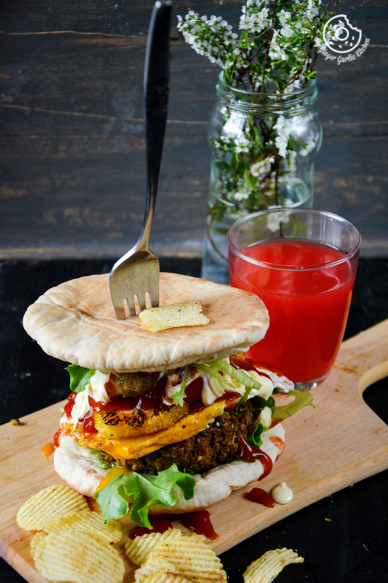 a mung bean pita burger with caramelised oranges and mango chutney with a fork on a cutting board