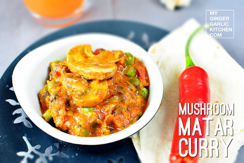a bowl of mushroom matar curry on a plate with a red chili