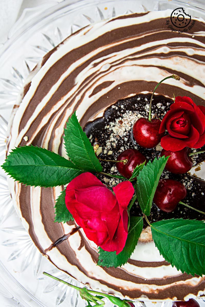 no bake zebra cheesecake with cherries and a rose on top