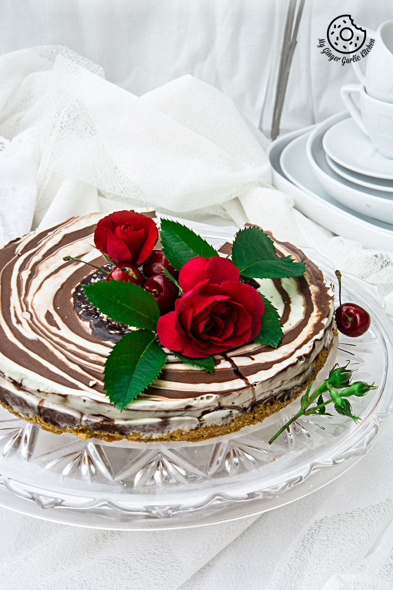 no bake zebra cheesecake with two roses on top of it
