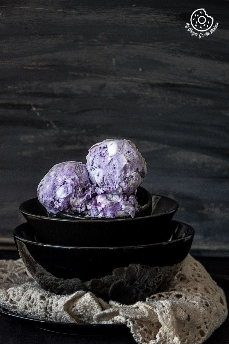 three scoops of no churn vegan coconut blueberry icecream in a bowl on a table