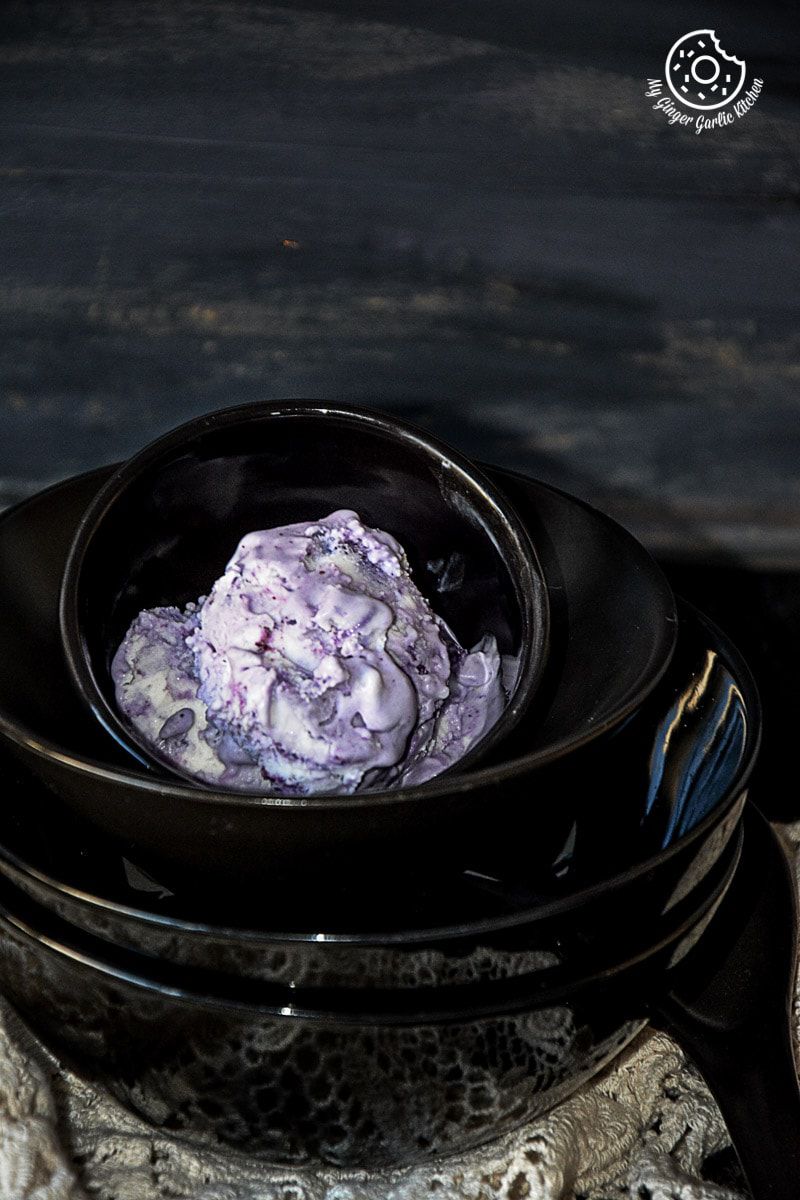 a bowl of no churn vegan coconut blueberry ice cream sitting on a table