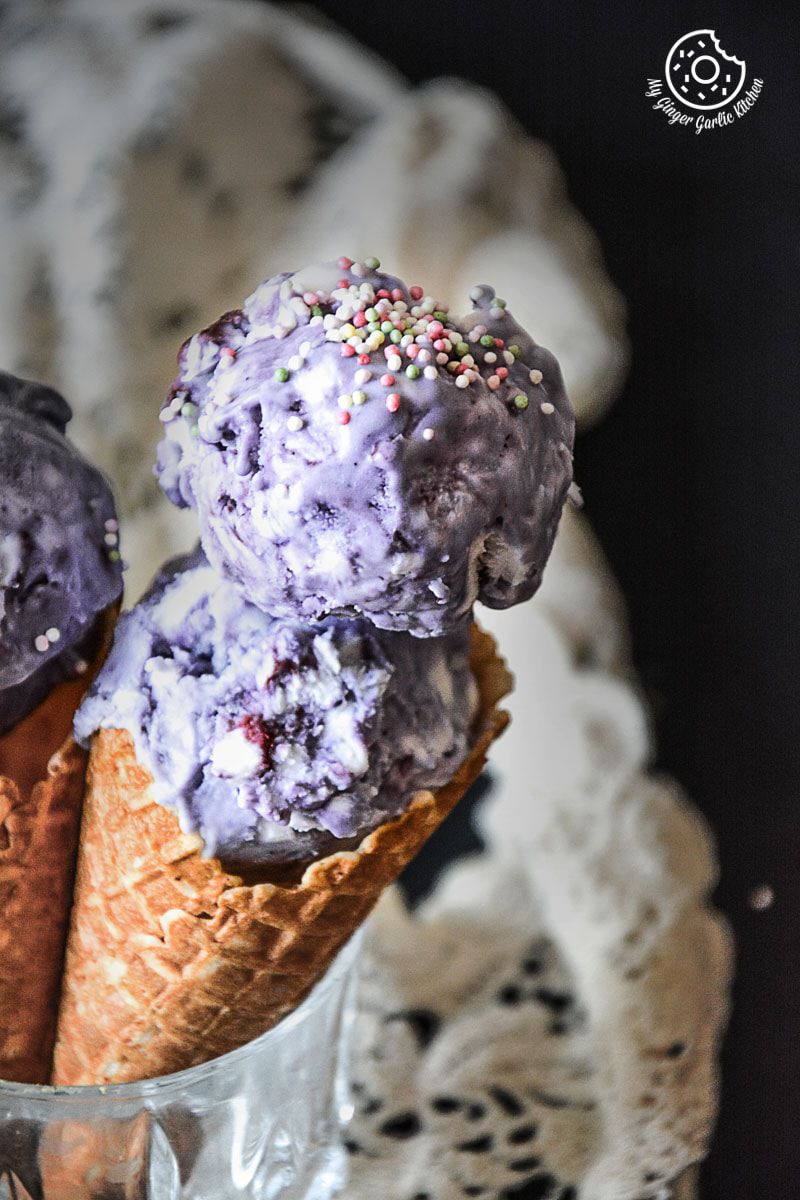 three cones of no churn vegan coconut blubberry ice cream with sprinkles in them