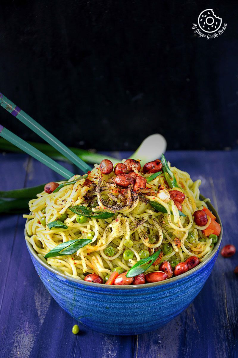 a bowl of no oil thai green curry chow mein noodles with peanuts and vegetables in it