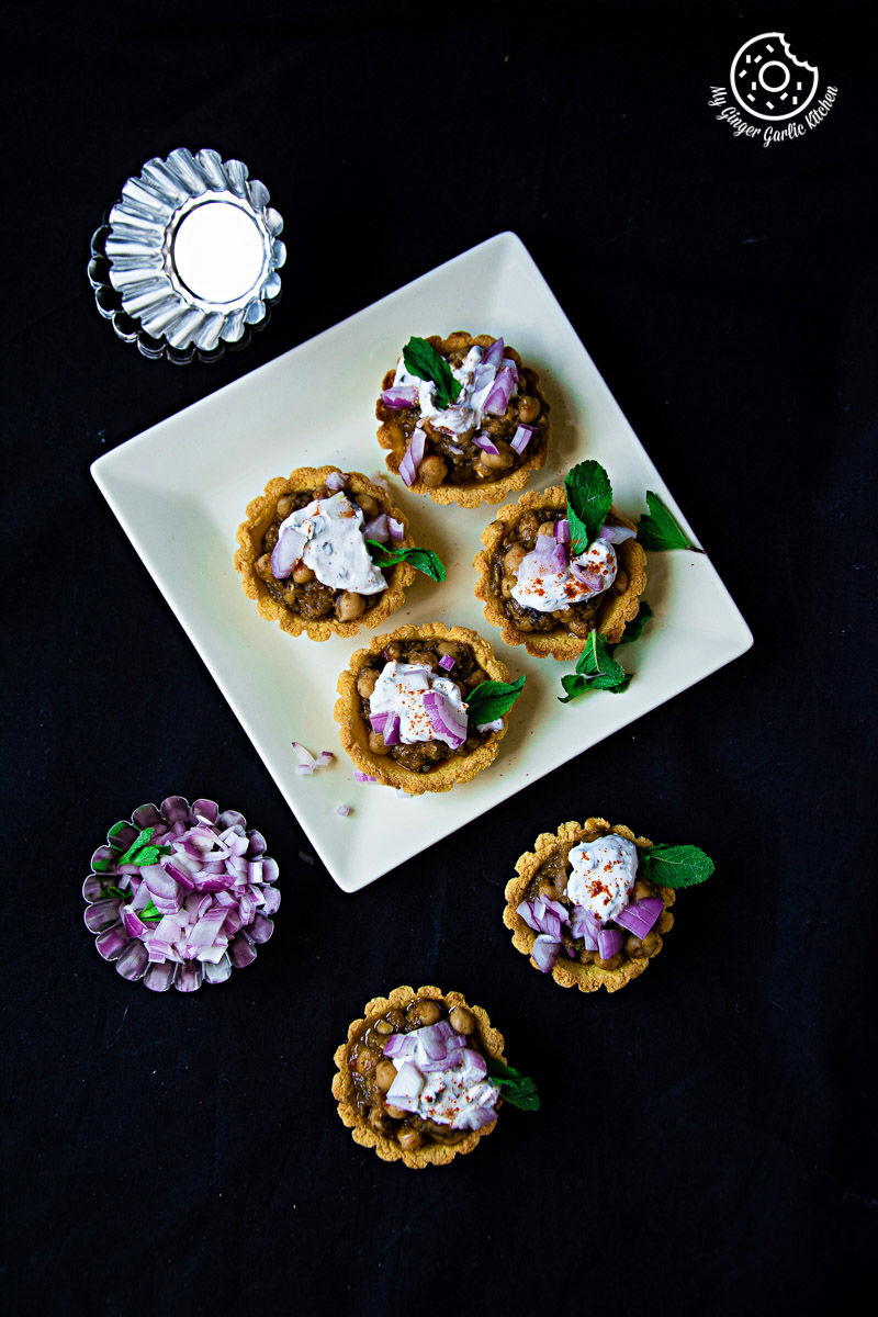 small zero oil mint chola cornmeal tart on a plate with red onions