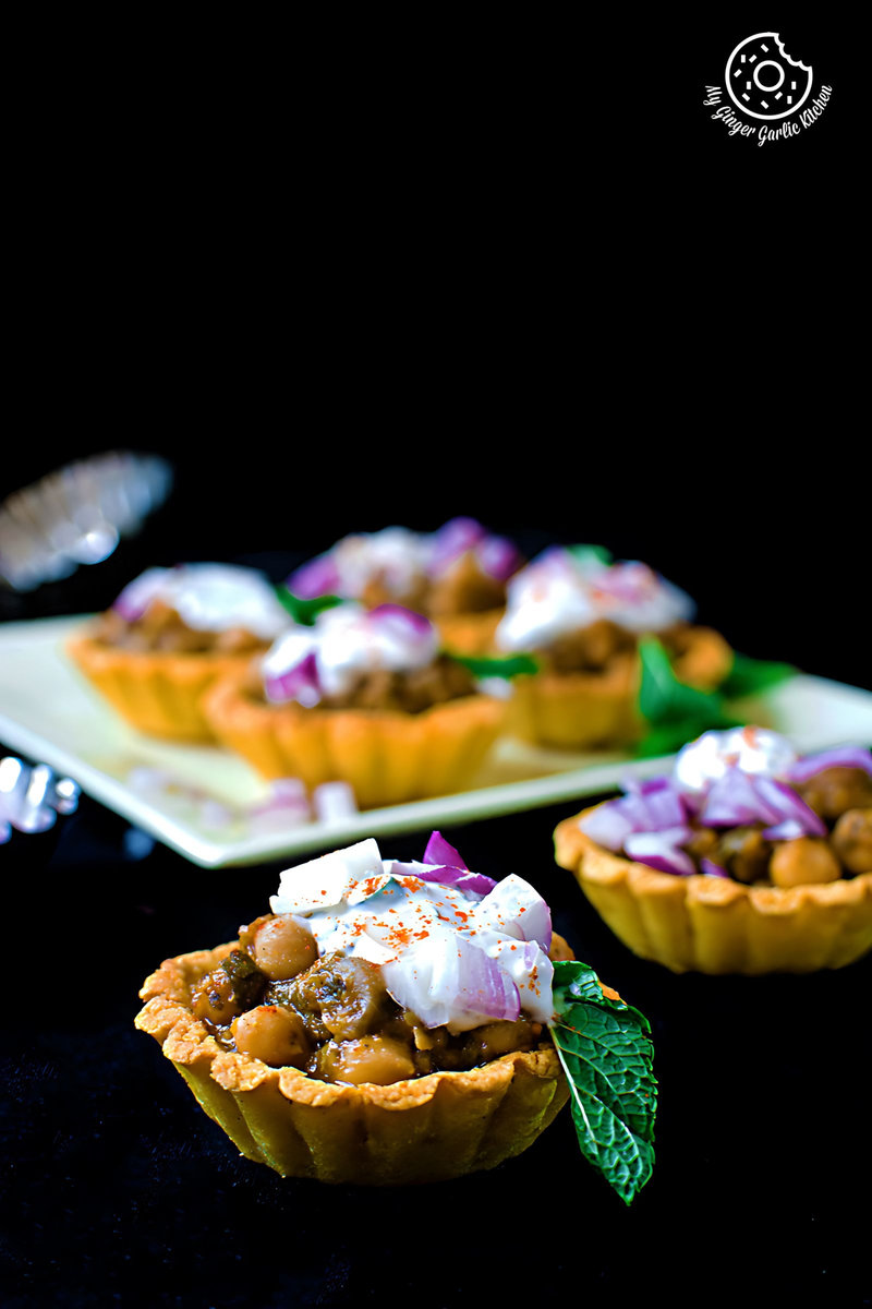 three small zero oil mint chola cornmeal tart with toppings on a table