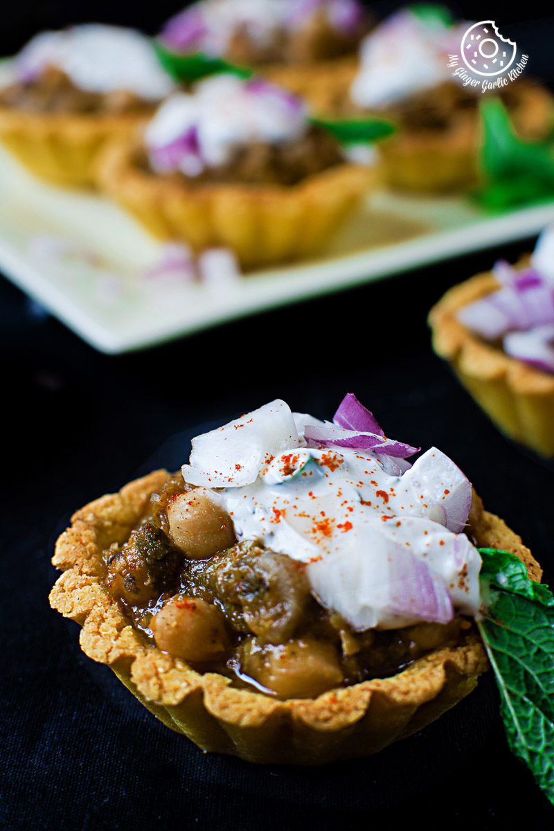 a small zero oil mint chola cornmeal tart with toppings on a table