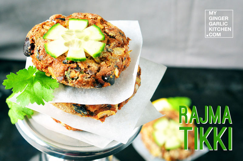 a stack of rajma tikki with cilantro on a plate with a cucumber on top