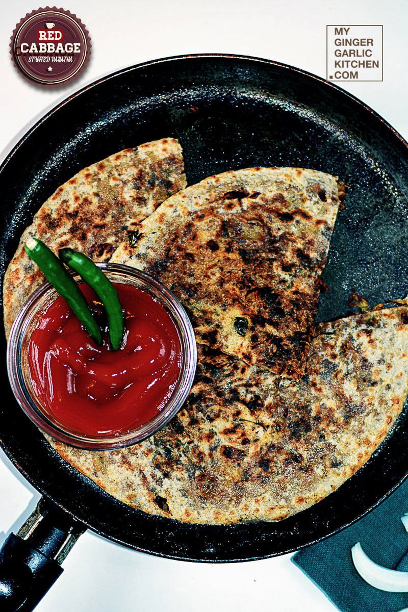 red cabbage paratha flatbreads in a pan with ketchup and sauce