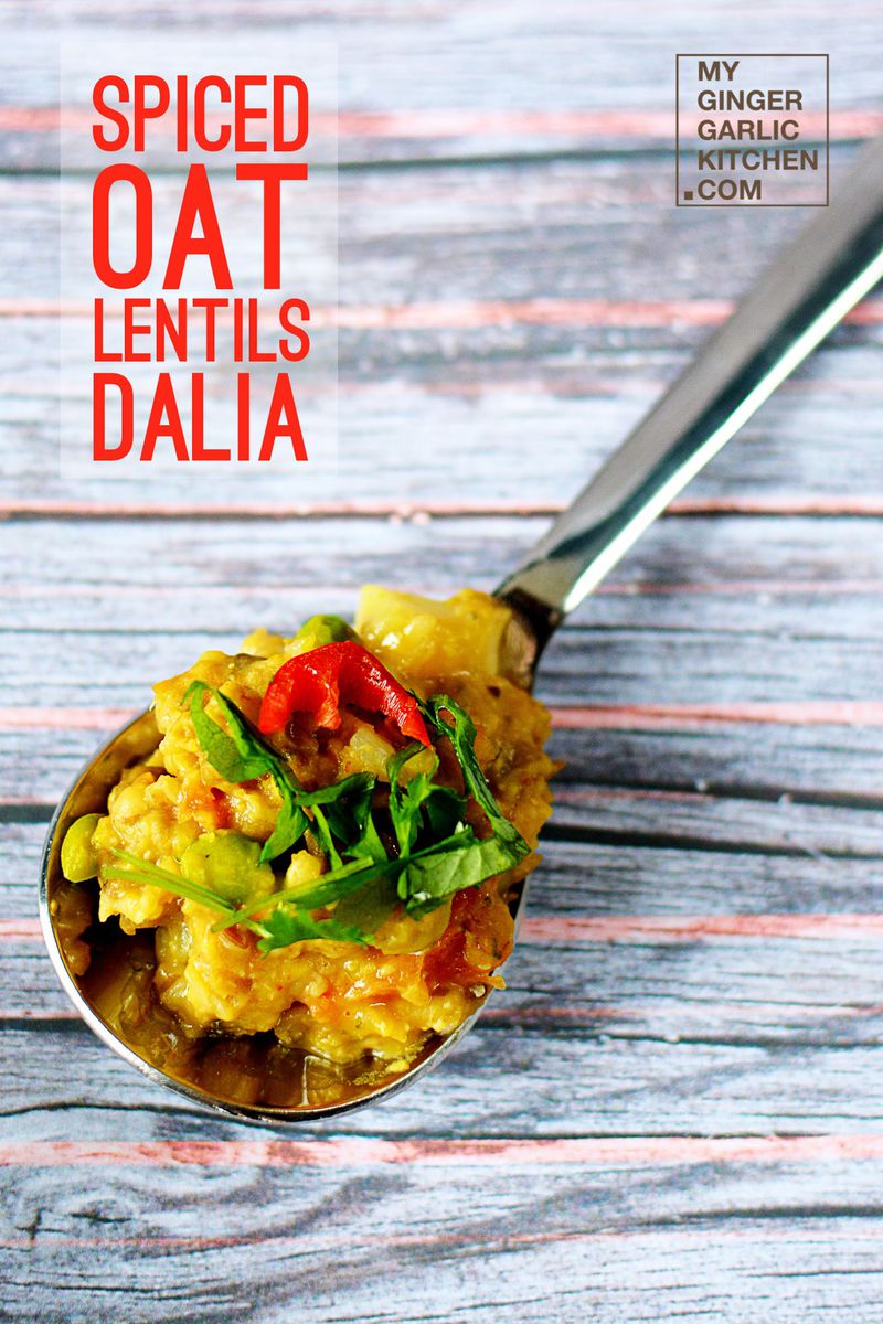 a spoon with a spoon full of spiced oat lentils dalia on it