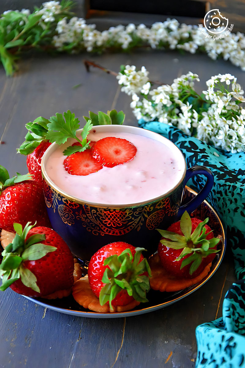 a bowl of strawberry cheesecake dip for fruits and snacks with strawberries