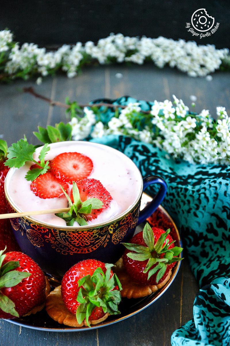 a bowl of strawberry cheesecake dip for fruits and snacks on a table