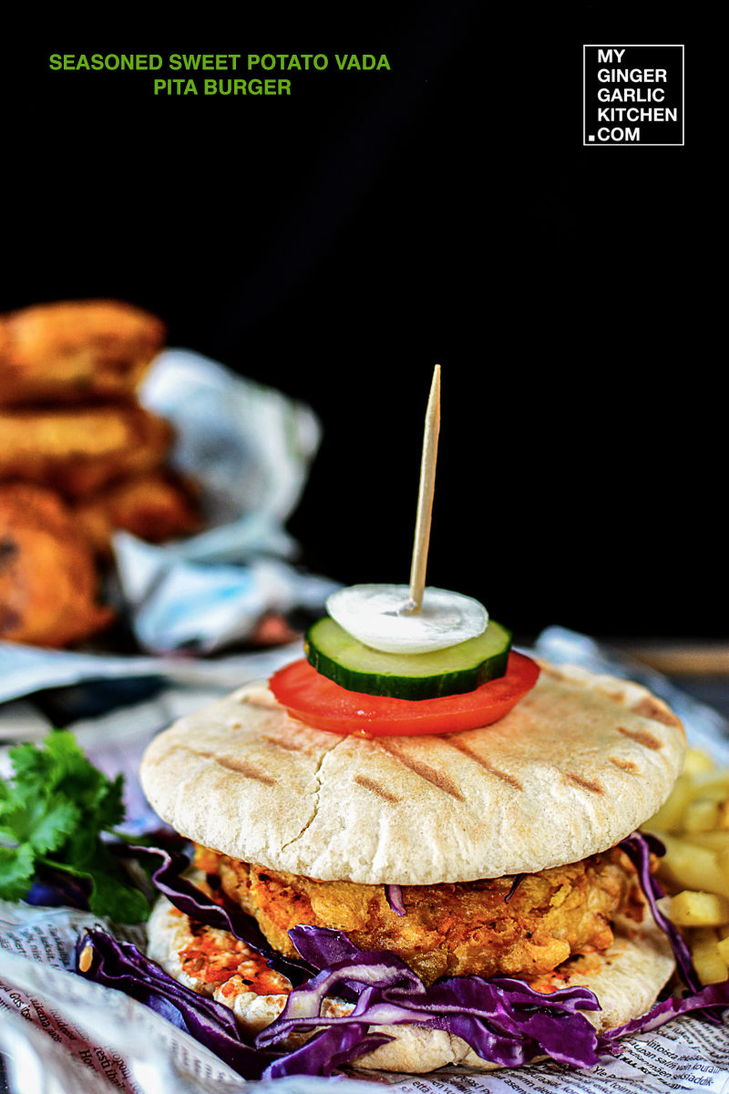 a sweet potato vada pita burger with a pickle on it