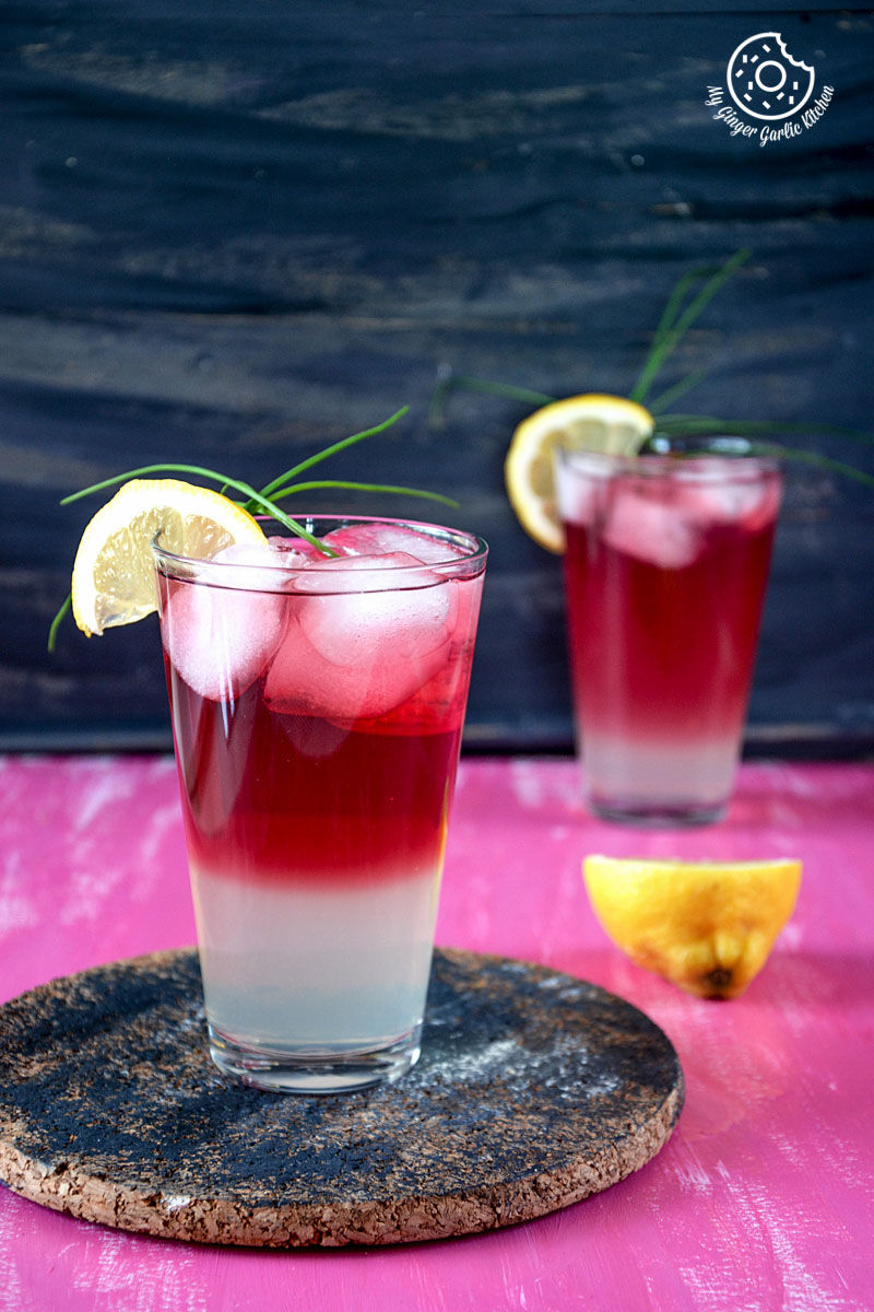 a watermelon lemonade drink with a lemon slice on the rim