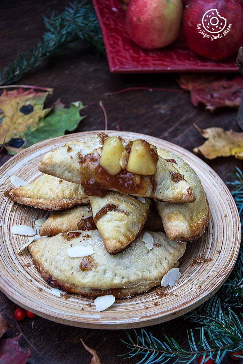 apple hand pies with almond flakes on a plate on a table