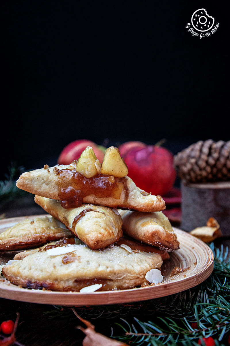 a plate of cookies with apples and cinnamon on it