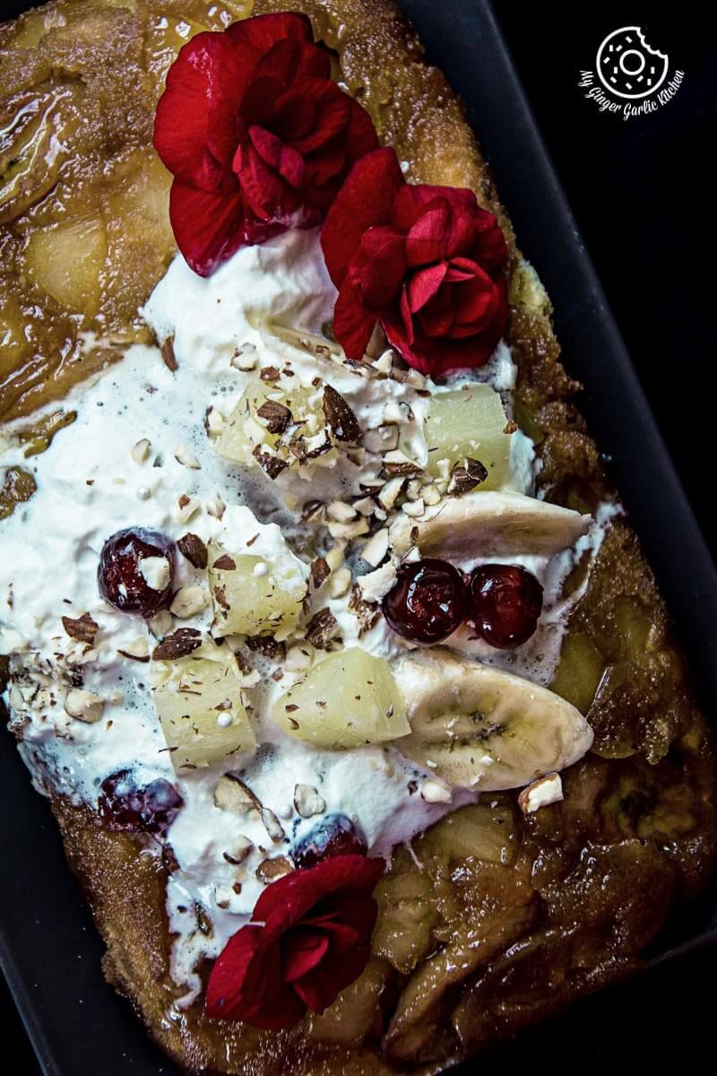 a banana pineapple upside down cake with toppings and flowers on it
