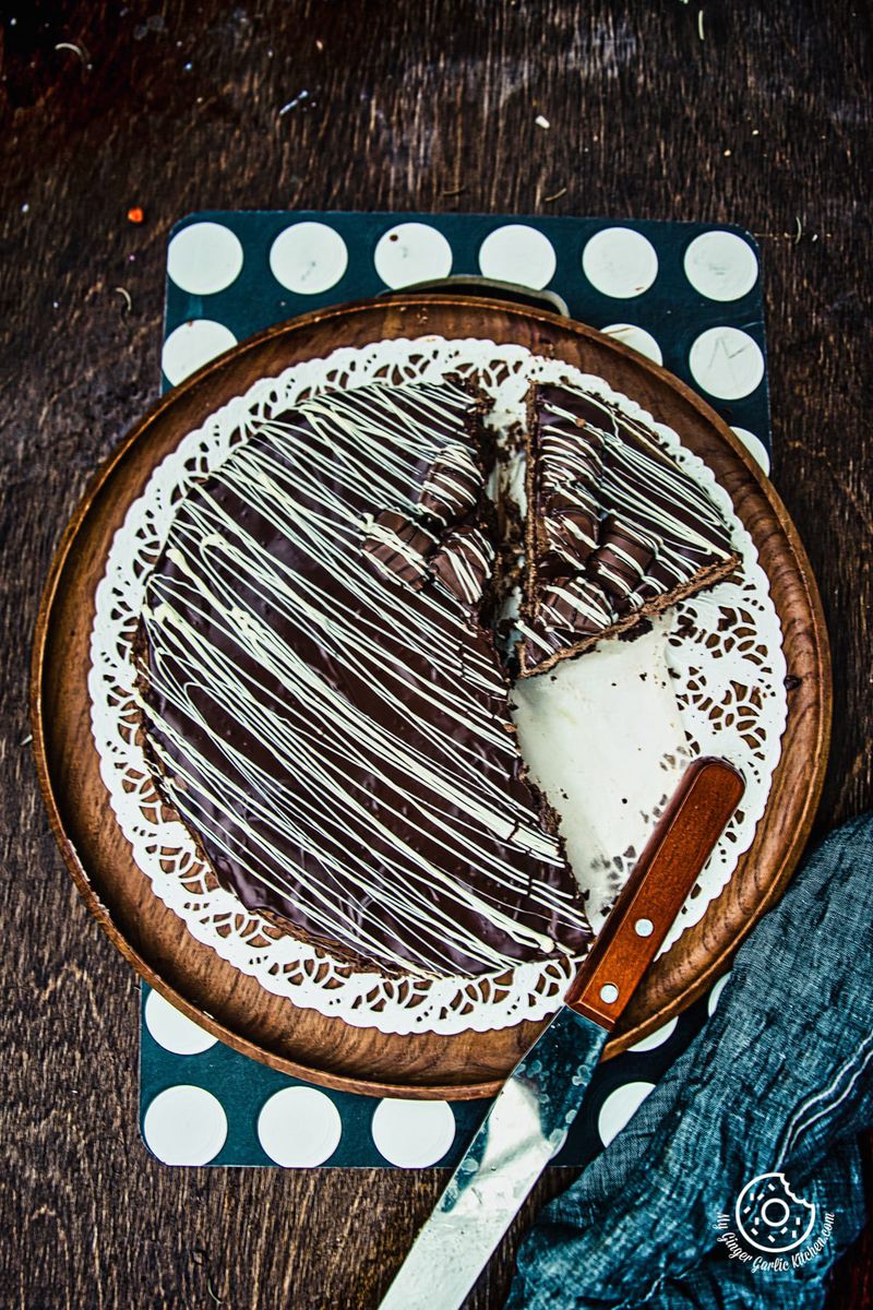 a chocolate cheesecake on a plate with a knife