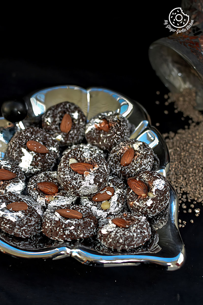 chocolate coconut delight topped with almonds in a silver plate on a table