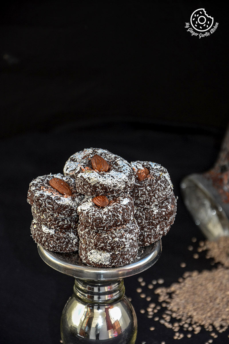 a stack of chocolate coconut delights topped with almonds