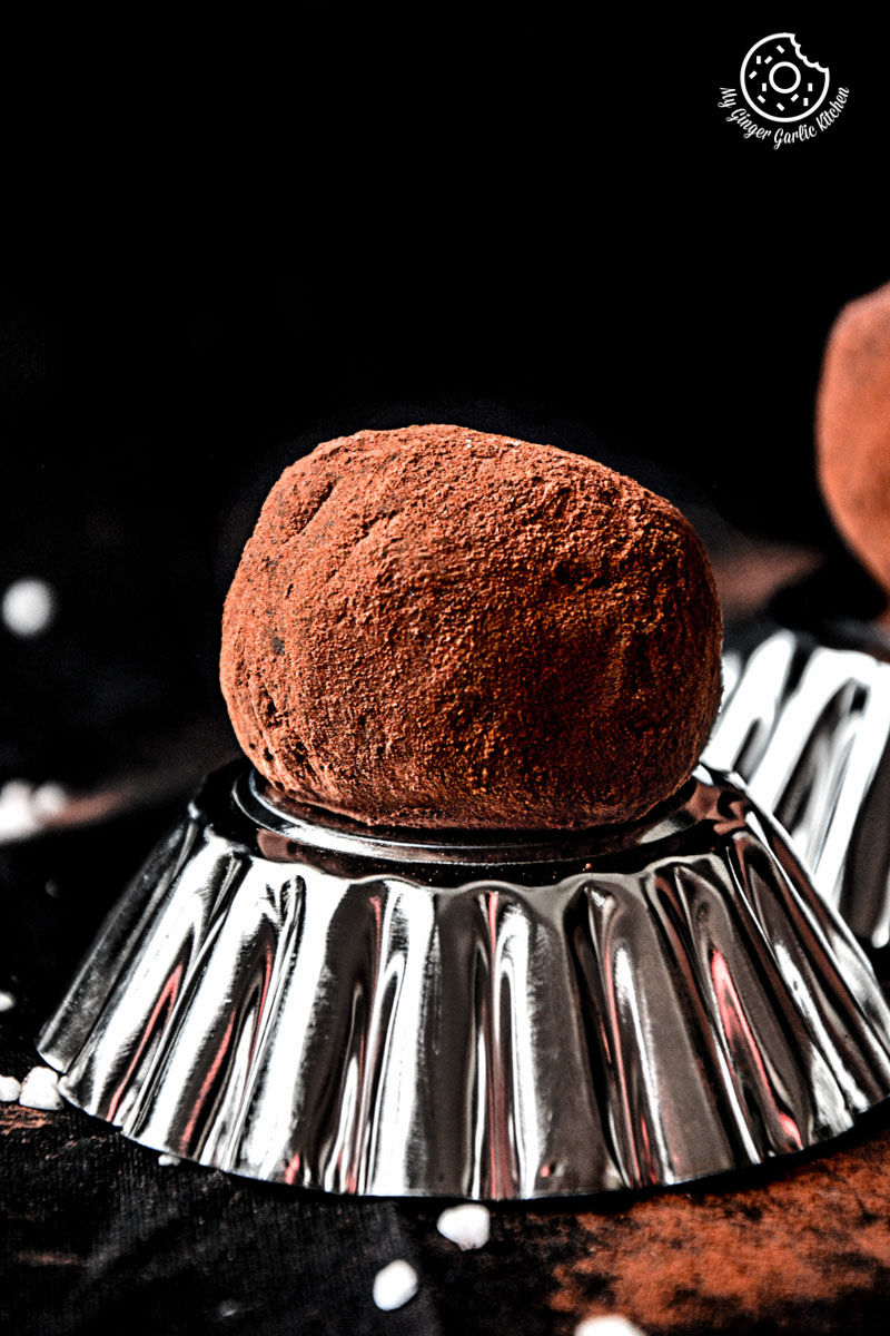 a coconut milk peanut butter truffles on a silver plate on a table