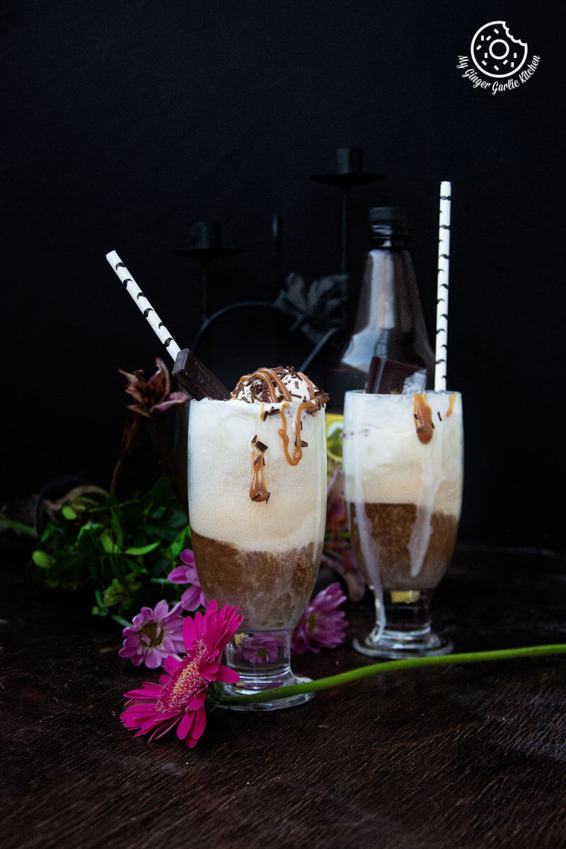 two glasses of home brewed beer float with ice cream, caramel sauce, and a side