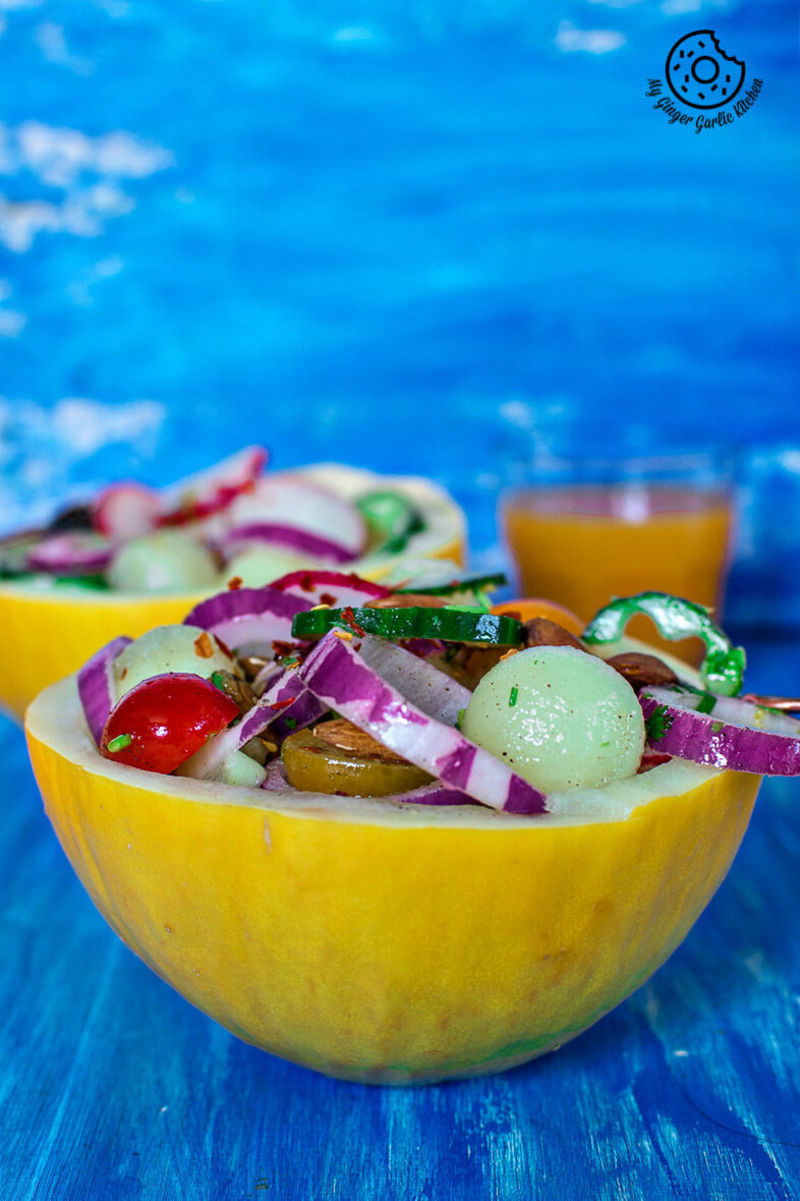 two honeydew melon radish salad bowls on a blue table