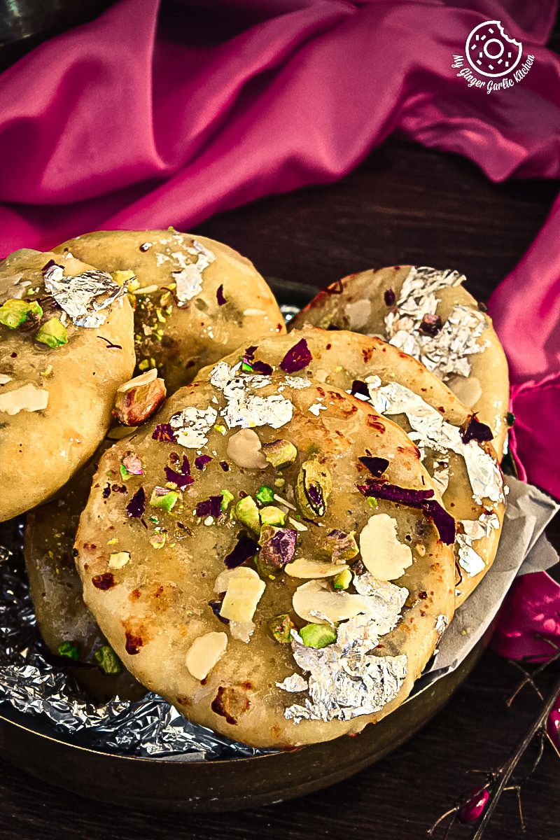 there are three Jaipuri Mawa Kachoris on a plate with a pink cloth