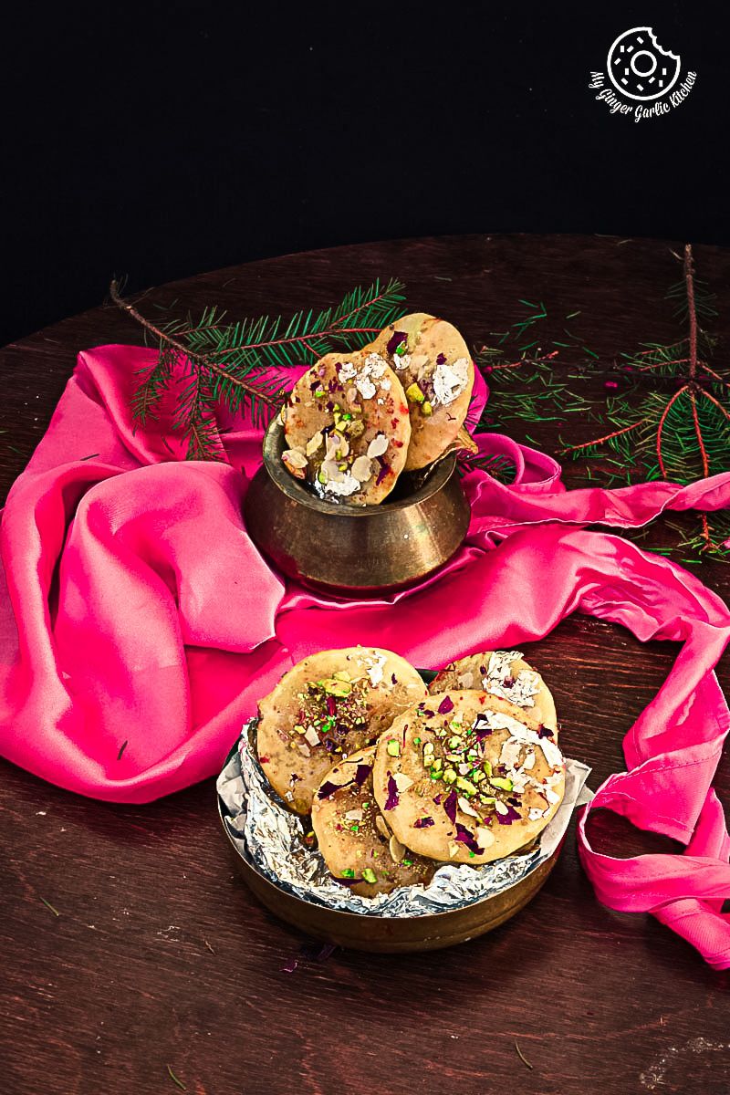 there are two bowls of Jaipuri Mawa Kachoris on a table with a pink cloth