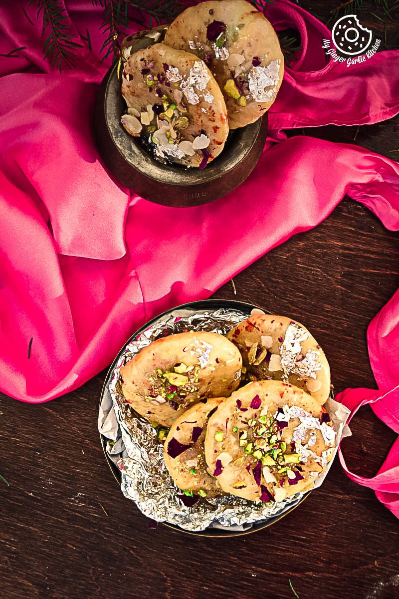 there are two plates of jaipuri mawa kachoris on a table with a pink cloth