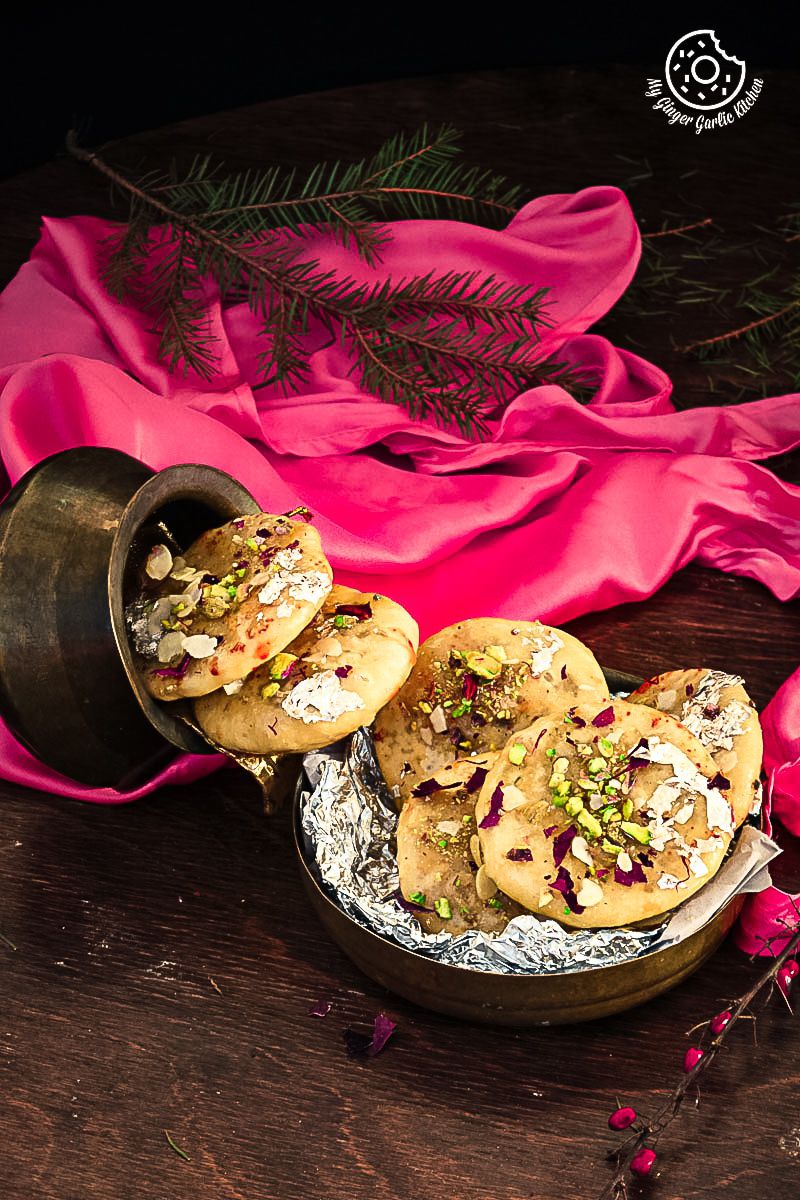 there are three small plates of Jaipuri Mawa Kachoris on a table