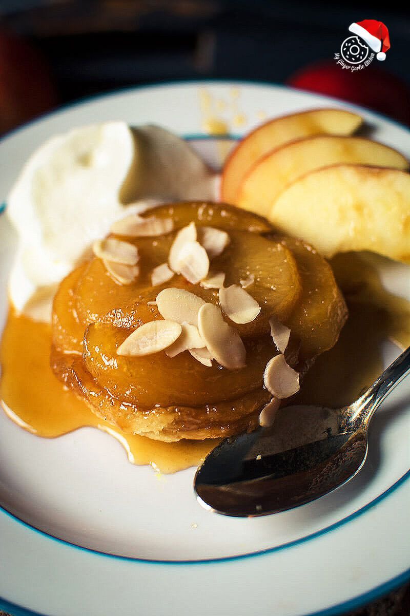 a plate of mini apple pear tarte tatin with apples and whipped cream