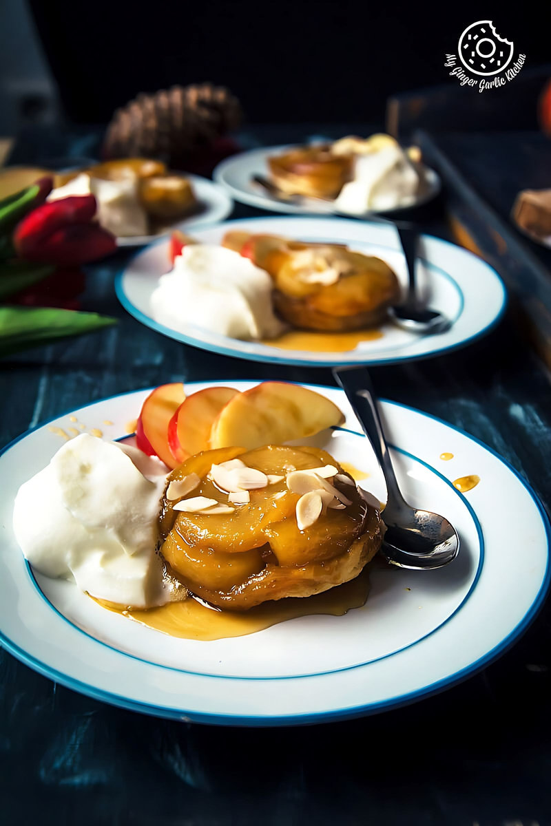 three plates of mini apple pear tarte tatin on a table with a spoon