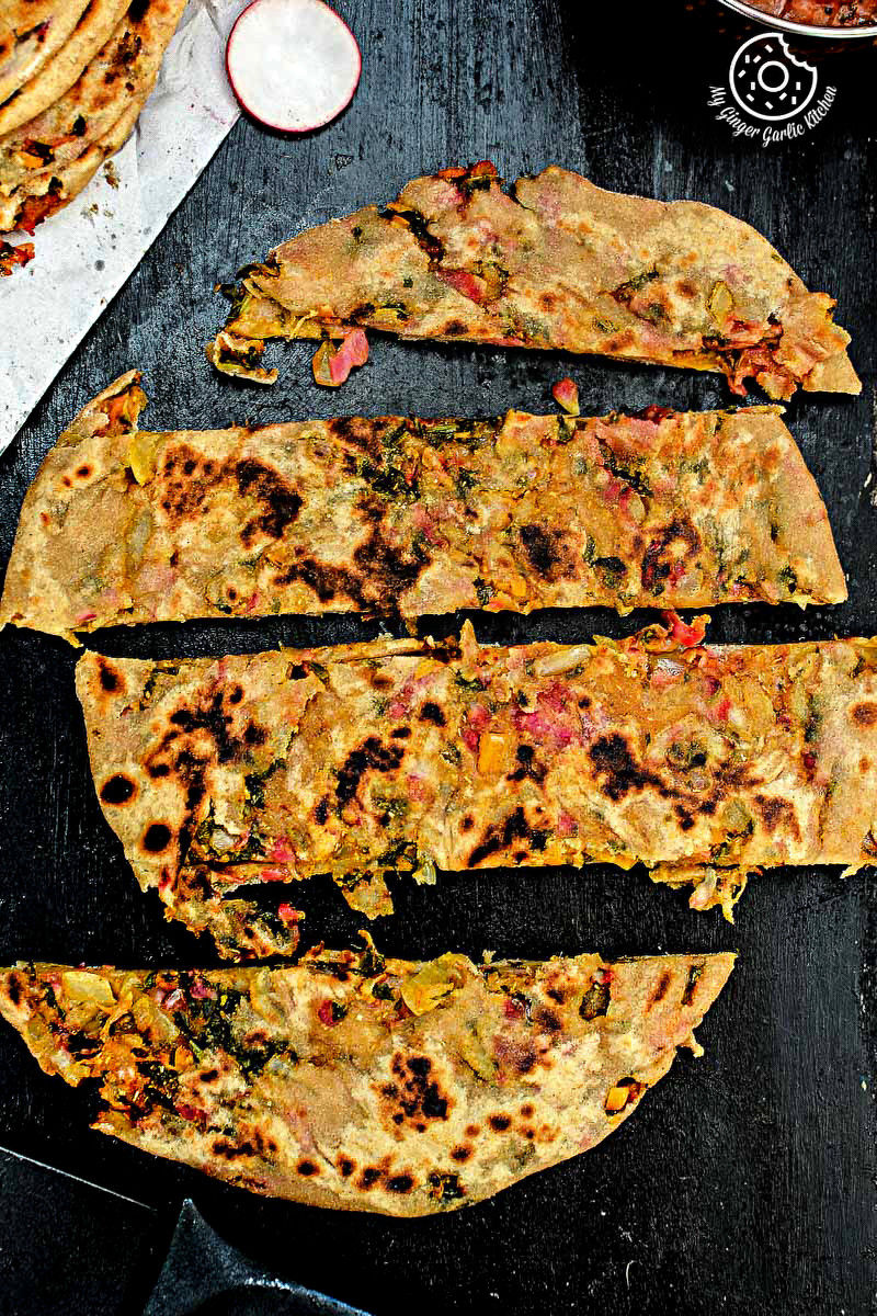 a mooli paratha that is cut into pieces on a table