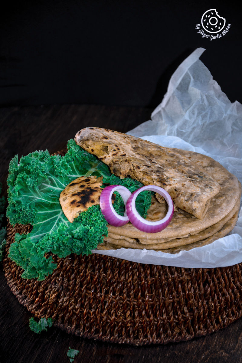 mushroom kale stuffed parathas with onions and kale on a plate
