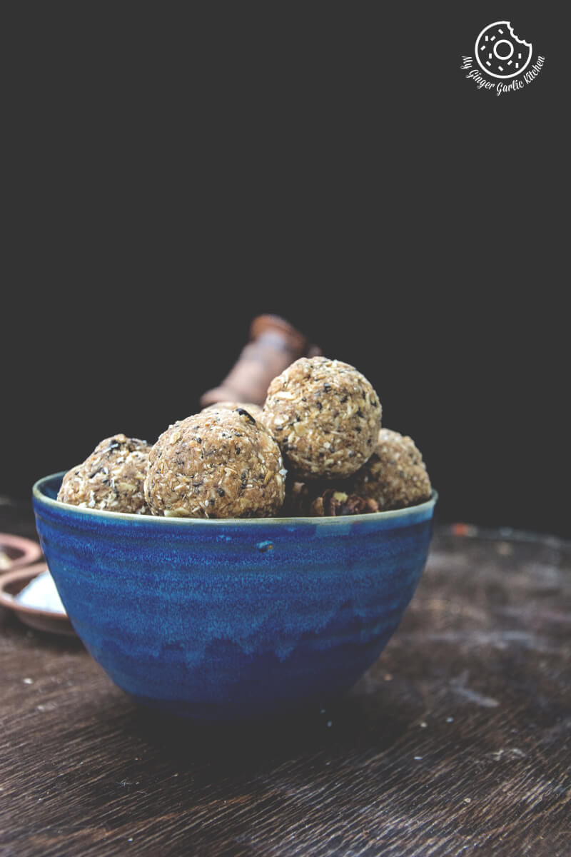 a blue bowl filled with no bake oats and chia energy balls