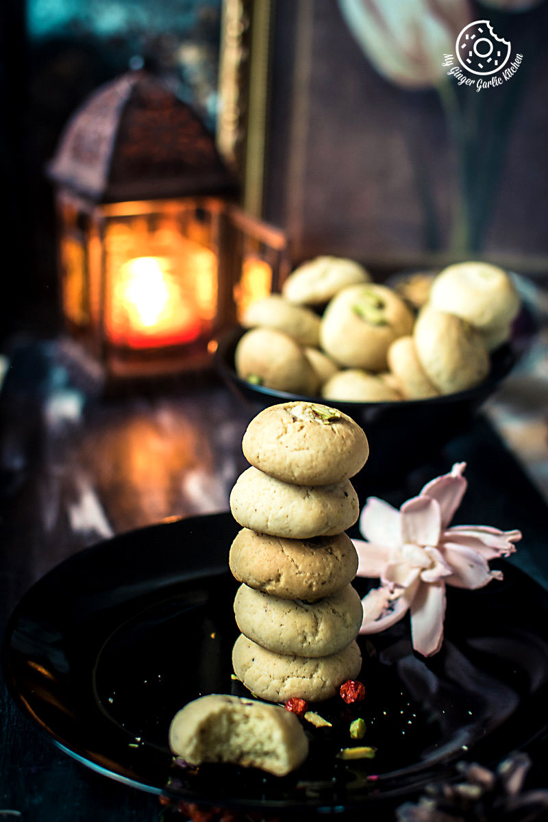 a few nankhatai cookies stacked on a plate on a table