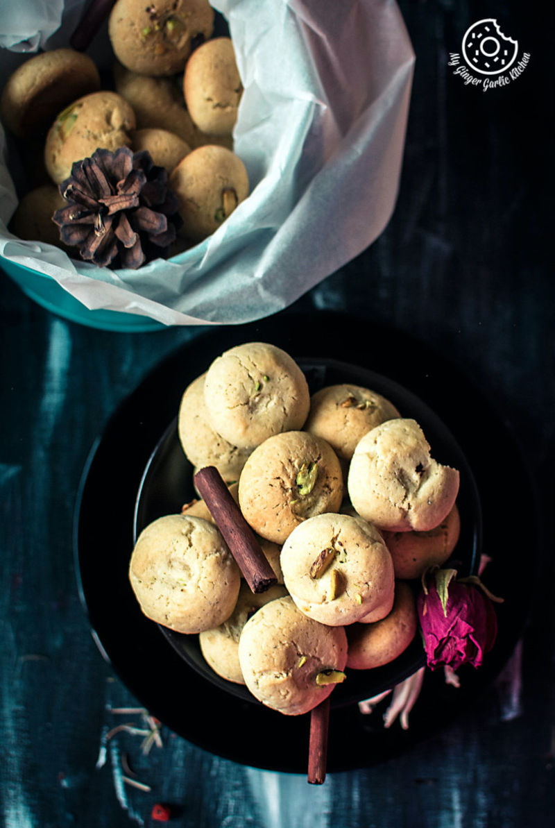 a plate of Indian nankhatai cookies and a bowl of naankhatai on a table