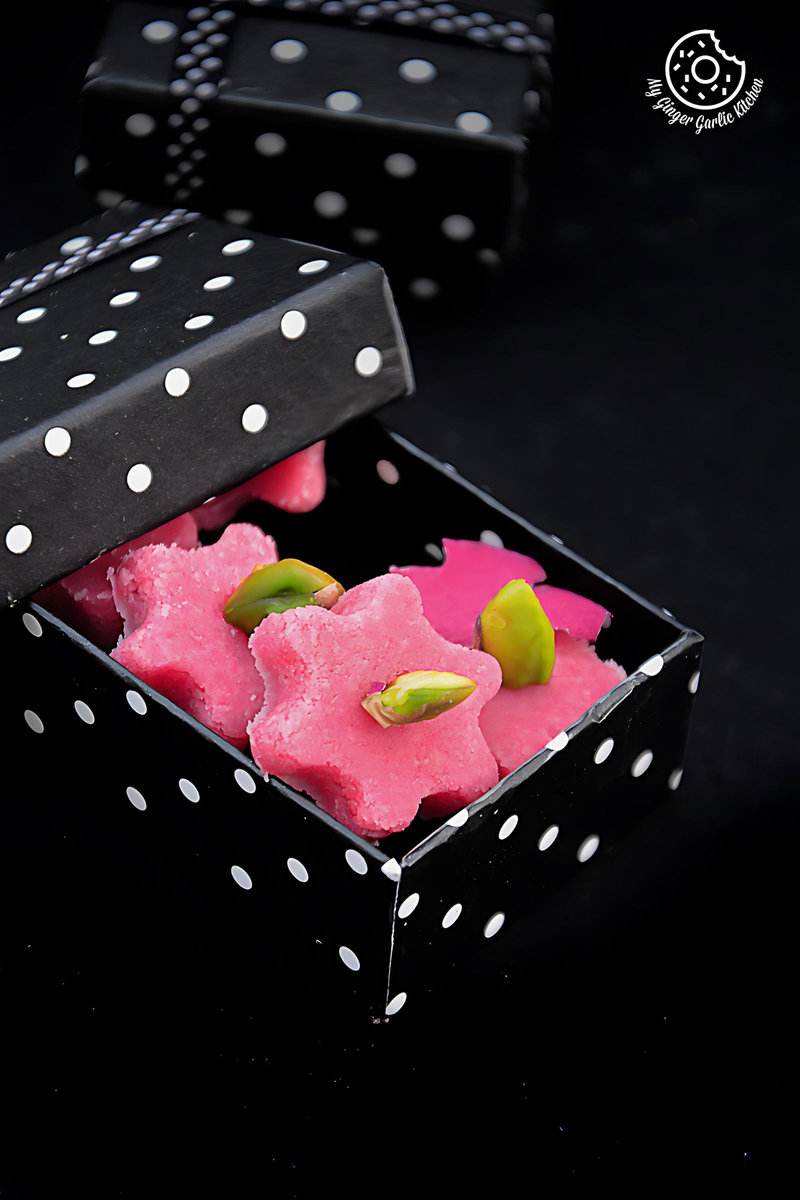 two boxes with pink and green no bake almond flowers in them