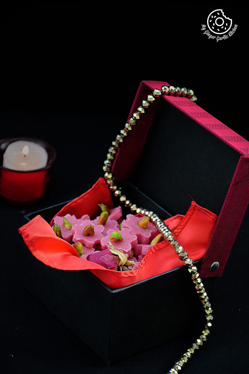 a box with a necklace and a bunch of no bake almond flowers in it