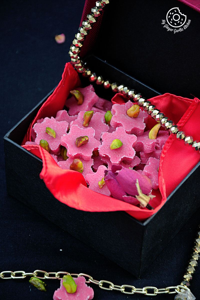 a box with a bunch of pink no bake almond flowers inside of it