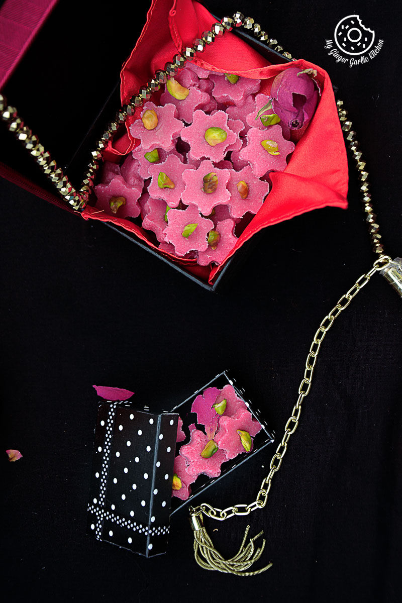 a pink purse with no bake almond flowers in it and a chain