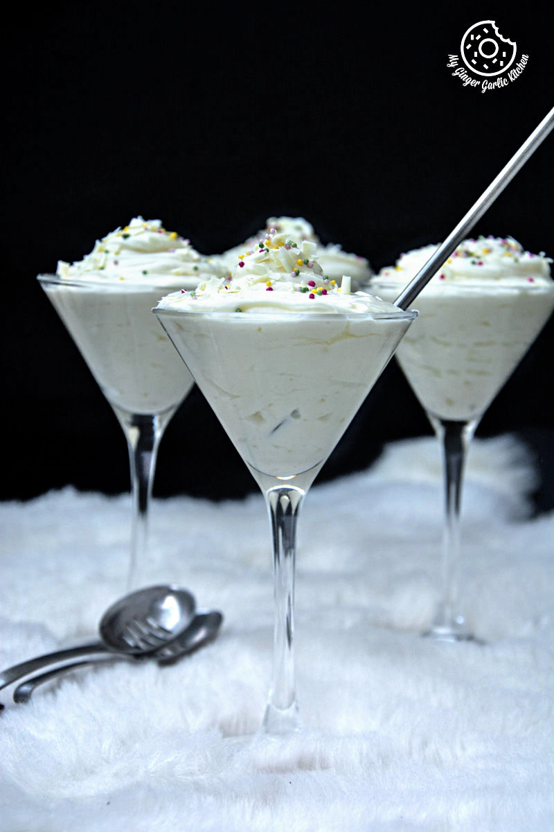 three glasses of no bake cream cheese lemon mousse with a spoon in them