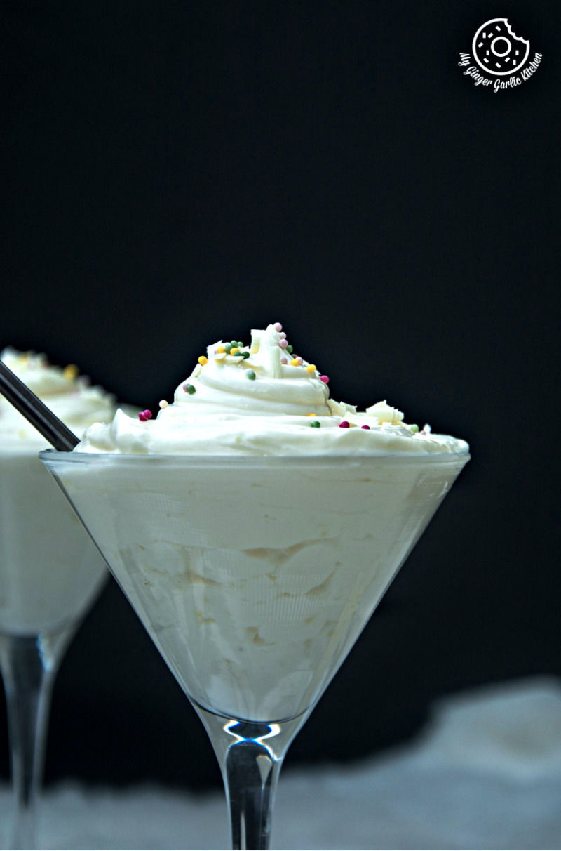 two glasses of no bake lemon cheesecake mousse with toppings