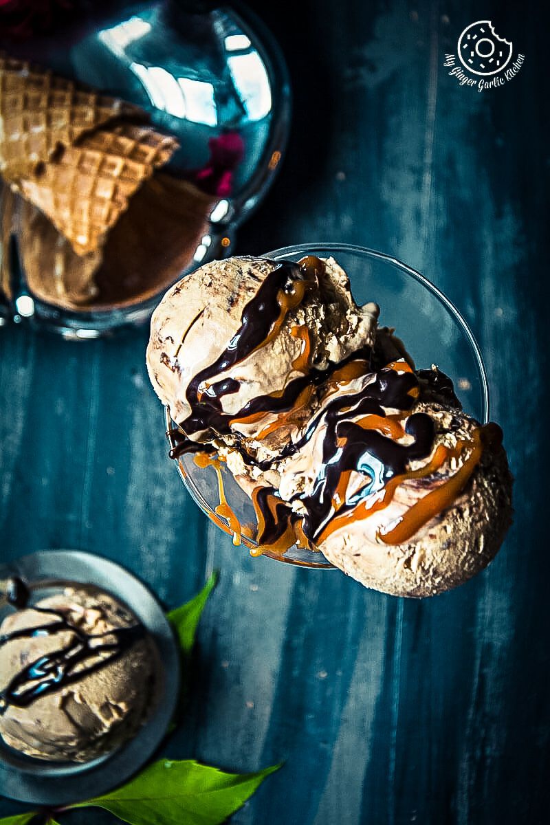 a scoop of no churn coffee caramel chocolate ice cream with chocolate sauce and caramel