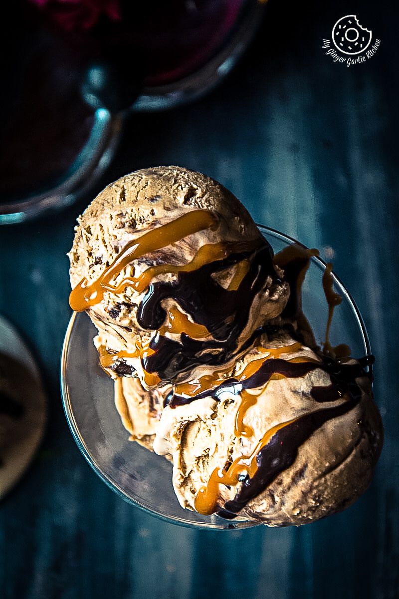 two scoops of no churn coffee caramel chocolate ice cream with chocolate and caramel on top