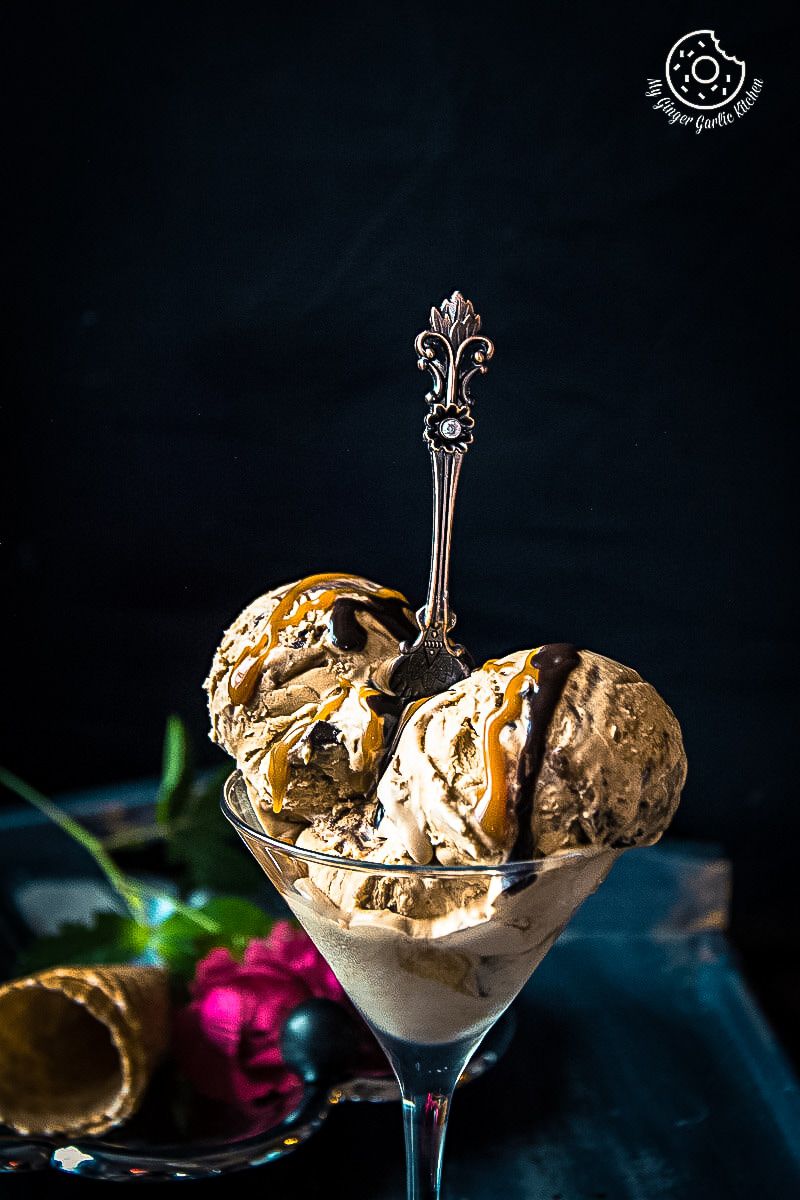 a glass of no churn coffee caramel chocolate ice cream with a spoon in it