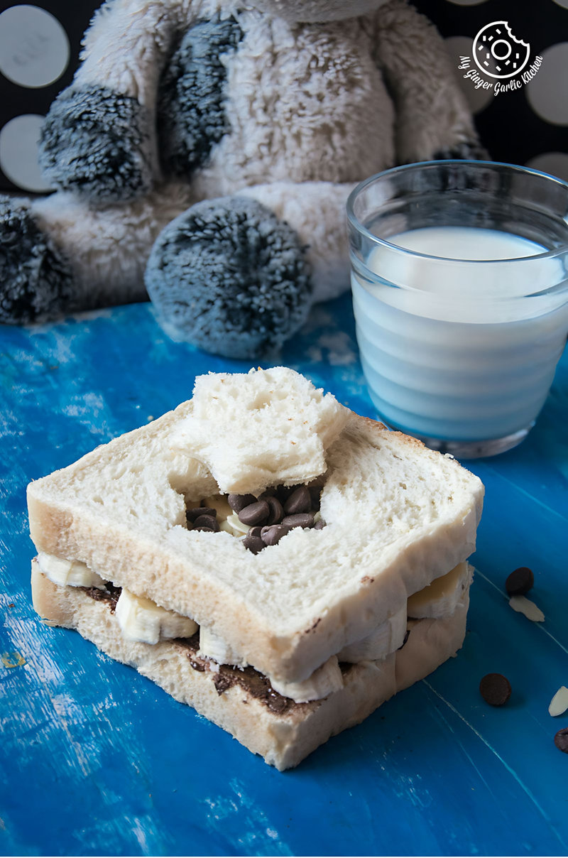 a peanut butter banana chocolate sandwich and a glass of milk